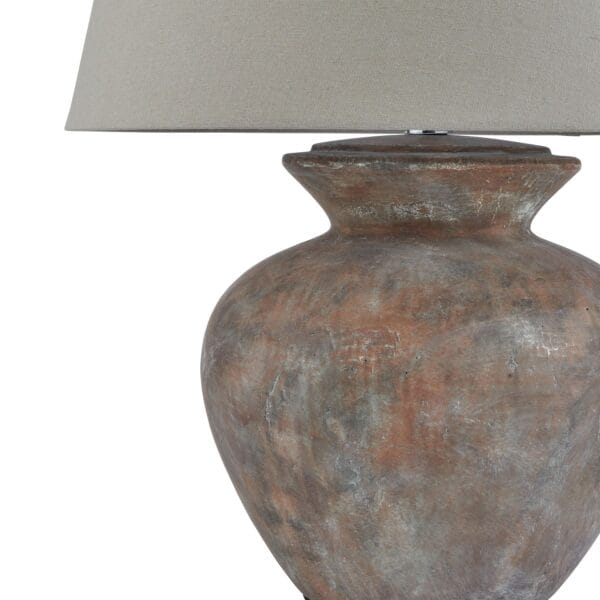 Topped with a neutral linen lampshade, the Siena Brown Round Table Lamp emits a soft, ambient glow, perfect for creating a cosy and inviting atmosphere in living rooms, bedrooms, or elegant hallway settings. Its earthy tones and classic silhouette make it a versatile piece that adds depth and warmth to any décor.