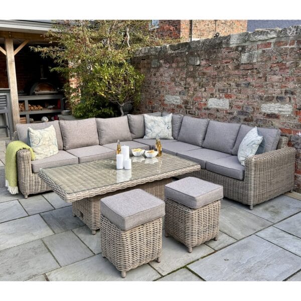 The modular corner seating arrangement provides ample space for family and guests, while the adjustable riser table effortlessly transitions between a casual coffee table and a dining-height table, making it perfect for al fresco dining or lounging. The addition of two matching stools ensures extra seating without compromising on style.
