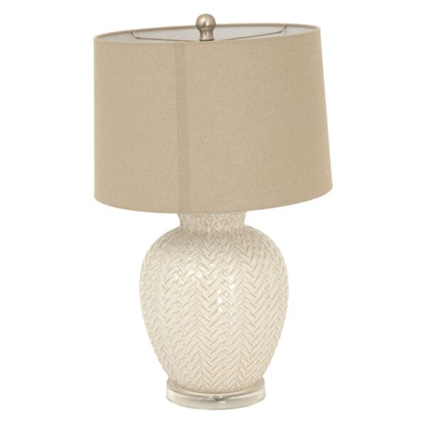 Topped with a neutral linen lampshade, the Twill Weave Ceramic Lamp diffuses a soft, ambient glow, creating a warm and inviting atmosphere in living rooms, bedrooms, or stylish office spaces. The delicate detailing and high-quality craftsmanship ensure it seamlessly blends into any refined space, adding depth, warmth, and a tactile element.