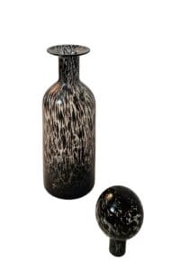 Elegant black and white glass bottle with round lid showcasing modern, timeless design